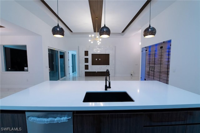 kitchen with dishwasher, sink, a center island with sink, and decorative light fixtures