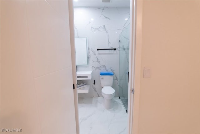 bathroom featuring a shower and toilet