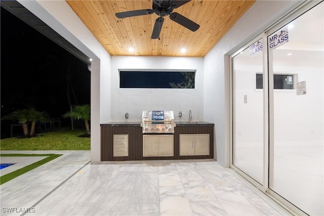 view of patio featuring exterior kitchen, a grill, sink, and ceiling fan