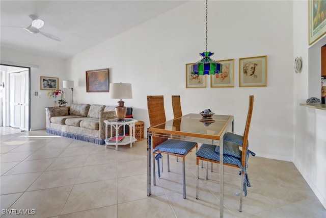 tiled dining room featuring lofted ceiling