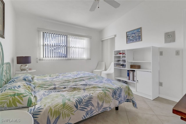 tiled bedroom featuring lofted ceiling and ceiling fan