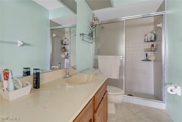 bathroom with vanity, a shower with shower door, tile patterned floors, and toilet