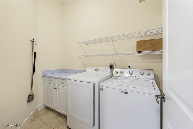 1538 Wilton Ln, Sanibel, FL 33957 - clothes washing area with light tile patterned floors, cabinet space, baseboards, and washer and clothes dryer