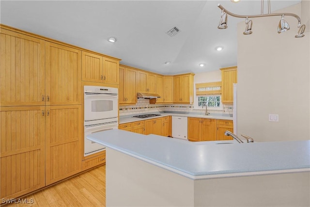 1538 Wilton Ln, Sanibel, FL 33957 - kitchen featuring light countertops, white appliances, under cabinet range hood, a sink, and visible vents