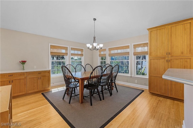 1538 Wilton Ln, Sanibel, FL 33957 - dining area with baseboards, light wood-type flooring, and an inviting chandelier