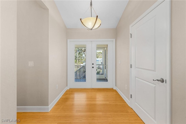 1538 Wilton Ln, Sanibel, FL 33957 - doorway to outside with french doors, baseboards, light wood-style floors, and vaulted ceiling