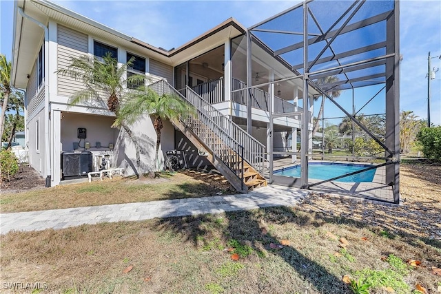 1538 Wilton Ln, Sanibel, FL 33957 - exterior space with stairway, cooling unit, a lanai, a patio, and an outdoor pool