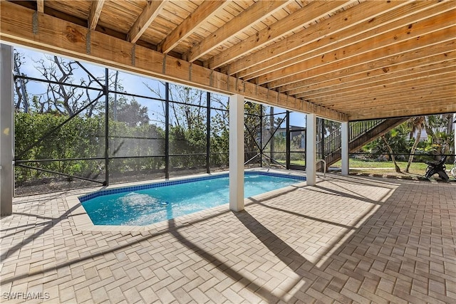 1538 Wilton Ln, Sanibel, FL 33957 - outdoor pool featuring glass enclosure and a patio area
