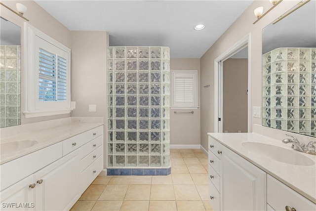 1538 Wilton Ln, Sanibel, FL 33957 - full bath with tile patterned flooring, baseboards, a sink, walk in shower, and two vanities