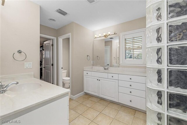 1538 Wilton Ln, Sanibel, FL 33957 - full bath with tile patterned flooring, toilet, a sink, visible vents, and two vanities