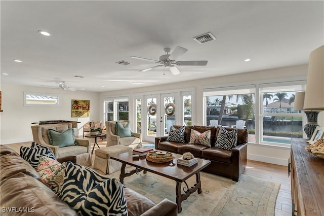 living room with french doors, ceiling fan, and light hardwood / wood-style floors