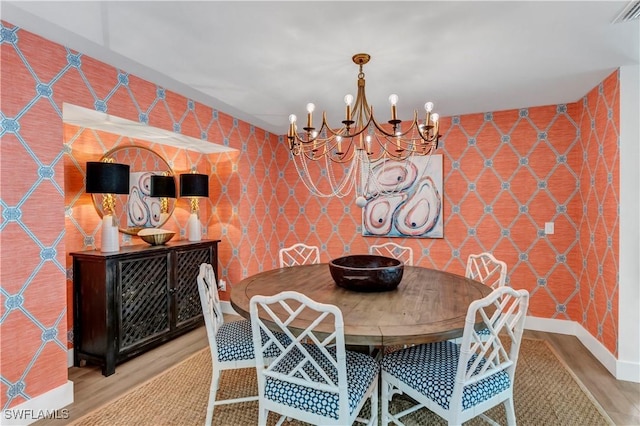 dining area featuring a notable chandelier and wood-type flooring