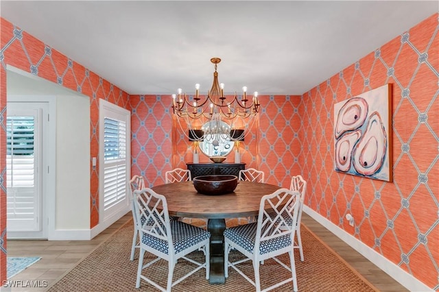 dining room with wood-type flooring and a chandelier