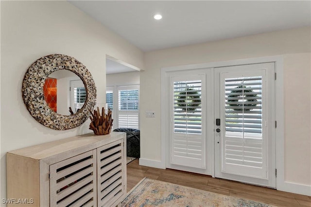 entrance foyer with light hardwood / wood-style floors and french doors