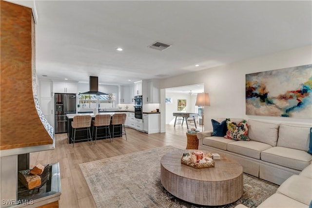 living room with light hardwood / wood-style flooring