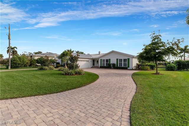 ranch-style house with a garage and a front lawn