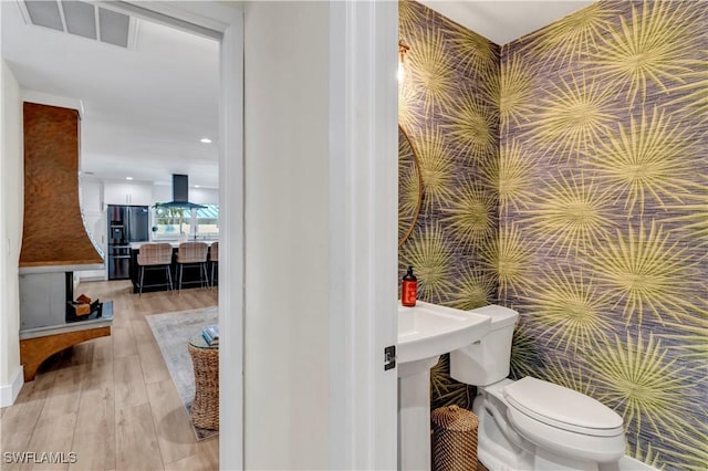 bathroom featuring toilet and hardwood / wood-style floors