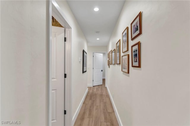 hallway with light hardwood / wood-style flooring