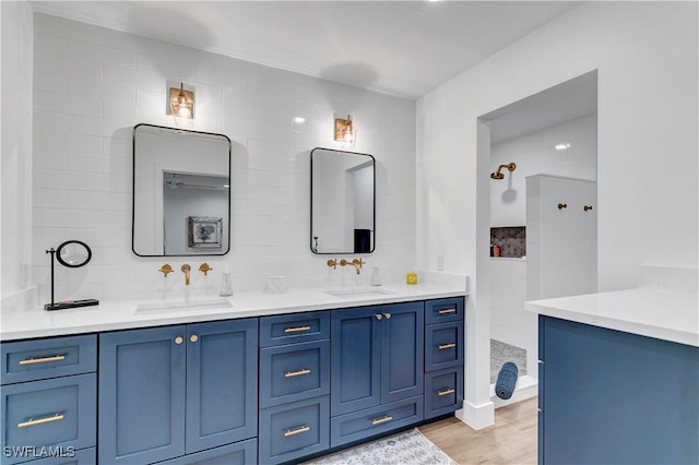 bathroom with vanity, hardwood / wood-style floors, and backsplash