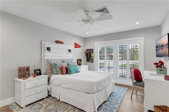 bedroom with ceiling fan, access to exterior, and hardwood / wood-style floors