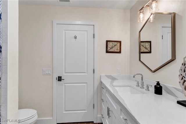 bathroom with vanity and toilet