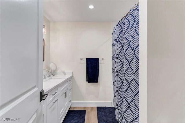 bathroom featuring vanity and wood-type flooring