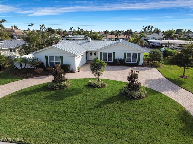 single story home featuring a garage and a front yard