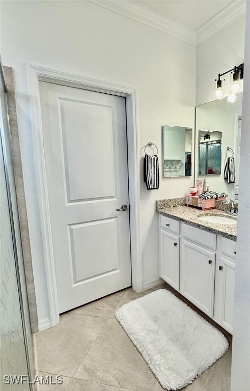 bathroom featuring ornamental molding and vanity