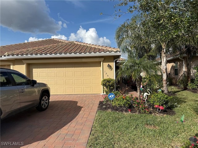 view of front of property featuring a garage and a front lawn