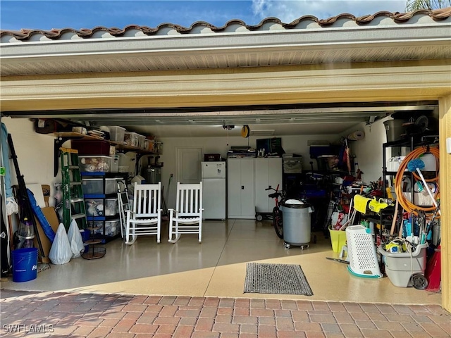 garage with water heater and white fridge