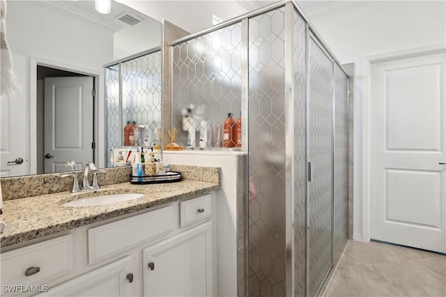 bathroom with vanity, ornamental molding, tile patterned floors, and a shower with shower door