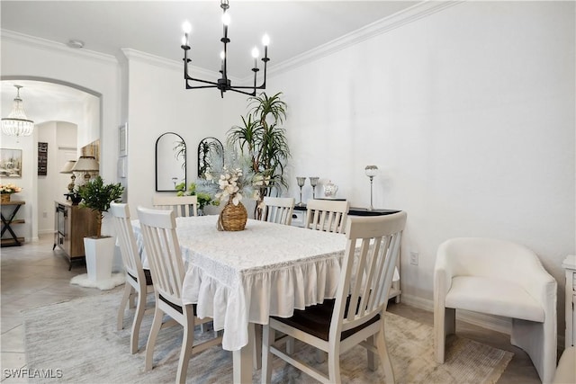 tiled dining space featuring an inviting chandelier and ornamental molding