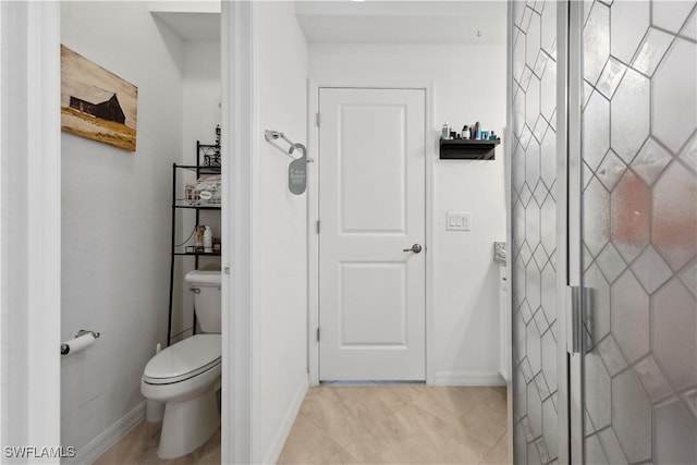 bathroom featuring tile patterned floors and toilet