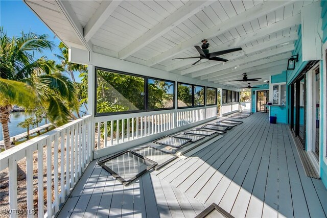 wooden deck featuring a water view and ceiling fan