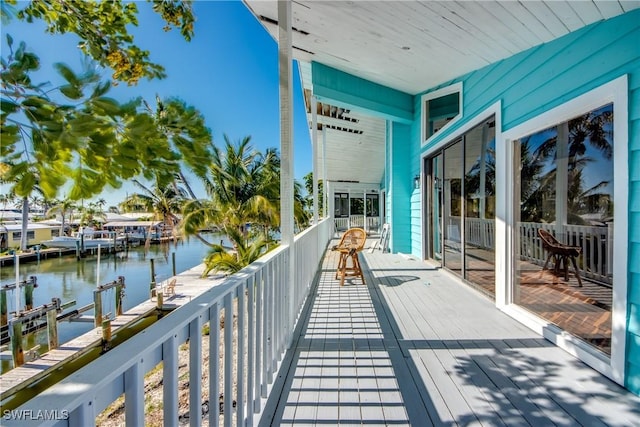 balcony featuring a dock and a water view