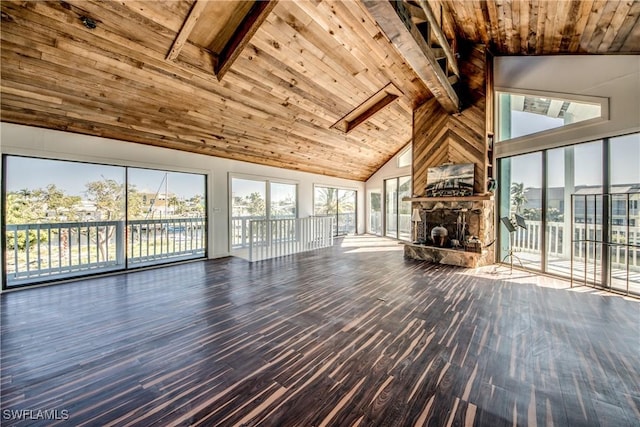 unfurnished living room featuring wood ceiling, hardwood / wood-style flooring, and a wealth of natural light