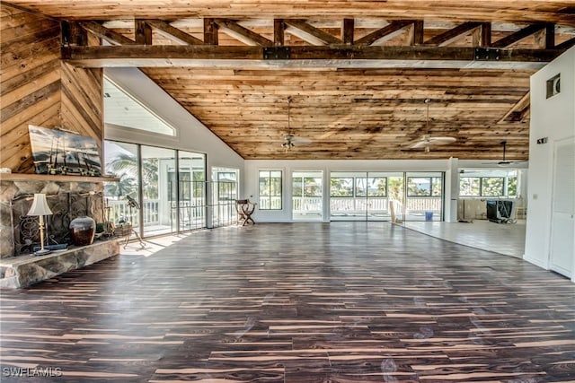 unfurnished living room with a stone fireplace, wood-type flooring, and high vaulted ceiling