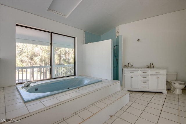 bathroom featuring vanity, tiled bath, tile patterned floors, and toilet