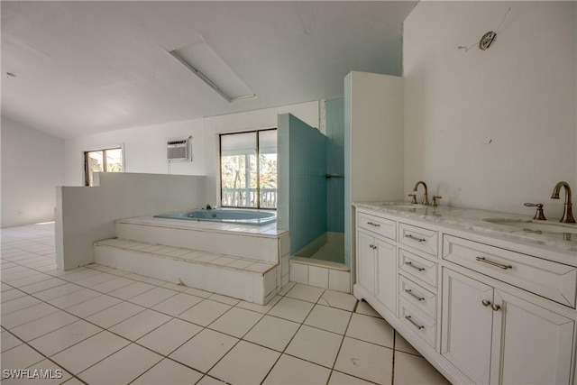 bathroom featuring plenty of natural light, tile patterned flooring, vanity, and tiled tub