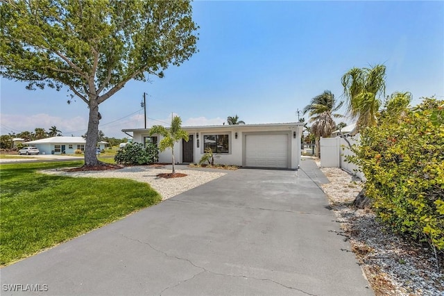 single story home with a garage and a front lawn