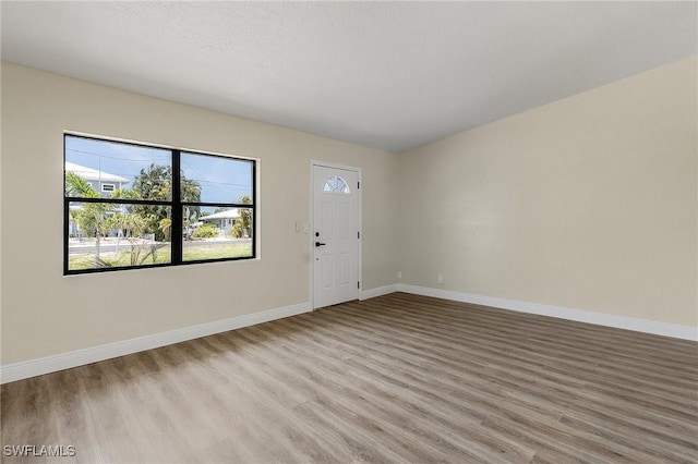 entrance foyer featuring a textured ceiling and light wood-type flooring