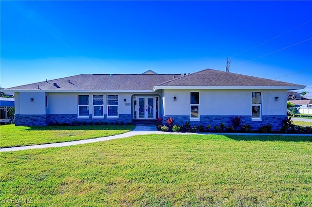 single story home with french doors and a front yard