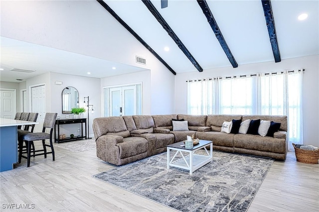 living room with high vaulted ceiling, beam ceiling, and light hardwood / wood-style flooring