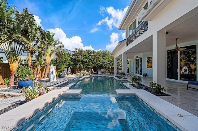 view of pool with a patio, a jacuzzi, pool water feature, and ceiling fan