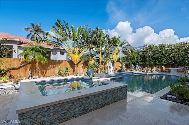 view of pool with an in ground hot tub and a patio area