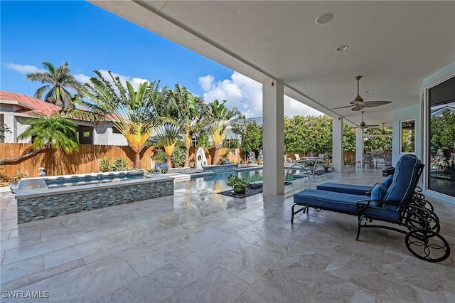 view of patio featuring a swimming pool with hot tub and ceiling fan