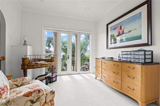 sitting room featuring crown molding, carpet flooring, and french doors