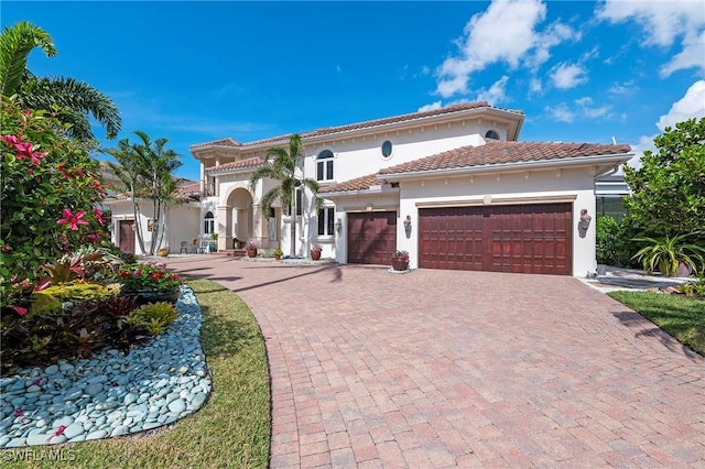 mediterranean / spanish home featuring a garage