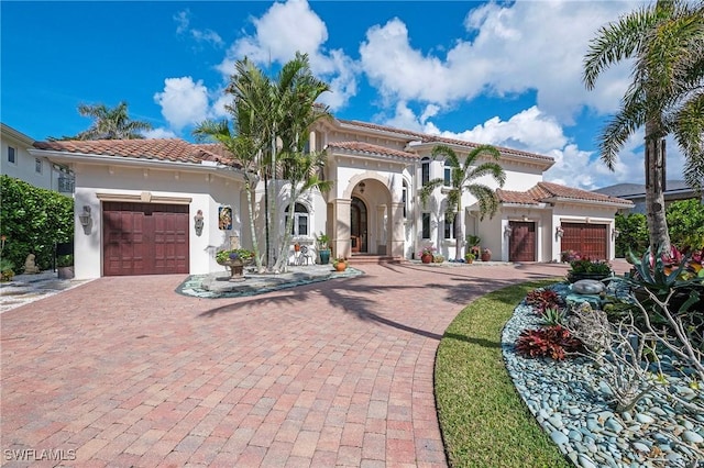 mediterranean / spanish house featuring a garage