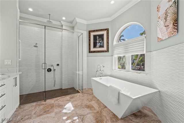 bathroom featuring crown molding, separate shower and tub, tile walls, and vanity